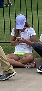 Young Girl Sitting on the Ground With Crossed Legs