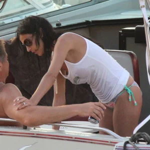 Bikini babe on a boat with a wet see through white shirt showing her tits