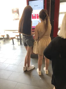 Couple of candid teens in shorts making order in fast food restaurand creepshots