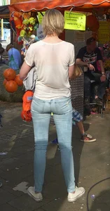 Hot milf with a firm and perky ass in tight blue jeans at the fun fair creepshot