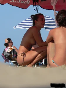 2 topless thonged sexy friends on the beach with great bodies