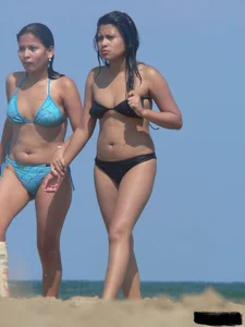 Couple of thick beach teens in little thong bikinis