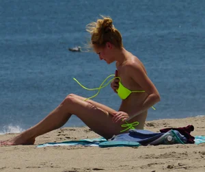 Sexy ass blonde milf on the beach in a thong with cameltoe and bending over