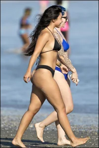 Two sexy ass friends at the beach in thong bikinis