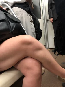 Hot crossed legs closeups in a subway train