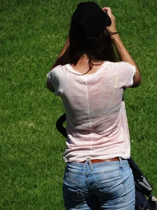 Skinny milf in tight jeans showing a bit of ass crack