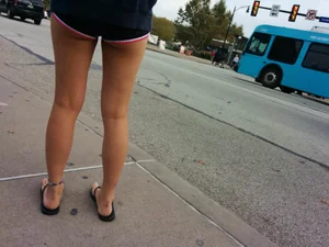Sexy Legs in Mini Shorts and Feet in Slippers on the Street Closeup Creepshot