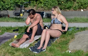 Thick blonde laying out in the sun in a bikini with her boyfriend