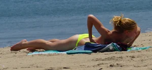 Sexy ass blonde milf on the beach in a thong with cameltoe and bending over