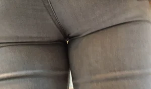 Girl with a tight ass in grey jeans going up the escalator