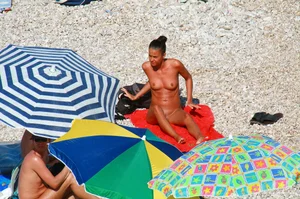 Ula FKK Sexy brunette on a nude beach topless, bottomless and with blue thong