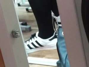 Feet of a Candid College Teen in Sneakers And Black Pantyhose