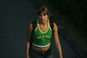 Pretty girl playing tennis in a skirt and walking in jeans