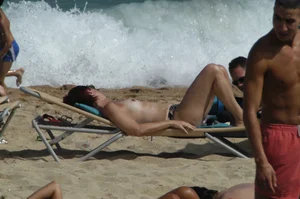 Topless girls on a beach in Barcelona