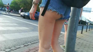 Girl walking in denim shorts showing some of her ass cheeks