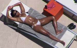 Girl with very oily skin lying on sunbed