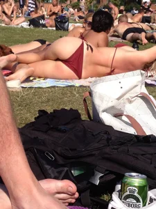 Hottie in a swimsuit lying in a park
