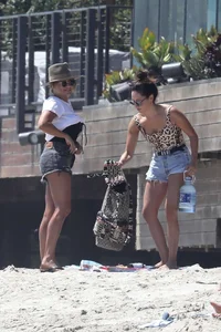 Ashley Tisdale in cheetah print swimsuit on the beach in Malibu