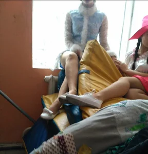 Candid Teens in Theatrical Costumes Chilling on the Windowsill in College Auditorium