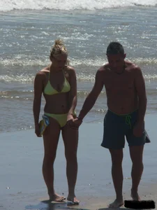 Sexy blonde on the beach in a yellow thong bikini
