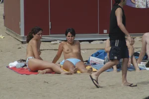 Topless girls on a beach in Barcelona