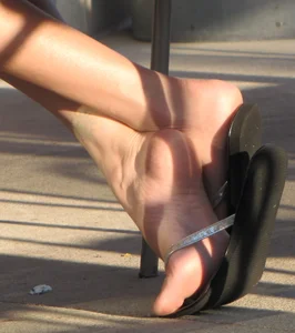 Lady in flop flops while eating showing her feet