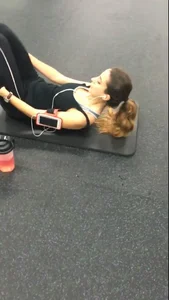 Sexy gym girl with a nice body in leggings as she works out
