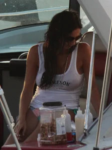 Bikini babe on a boat with a wet see through white shirt showing her tits