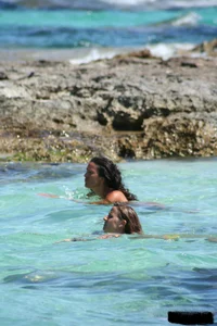 Nude beach ladies in the water showing their tits