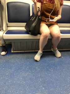 Girl with Hot Lets Sitting in a Subway Train - a Candid Peek under Skirt