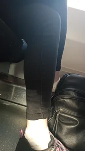 Legs in Tight Black Jeans And Ankles Closeup Creepshot in a Public Bus