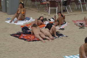 Topless girls on a beach in Barcelona