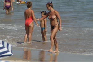 Girls on a nude beach in Sitges, Spain