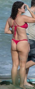 Thick brunette milf on the beach in red thong bikini