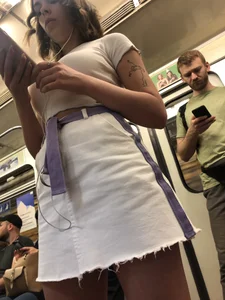 Candid Girl in a White Skirt and Sneakers With Hot Tanned Legs in Subway Train Creepshots