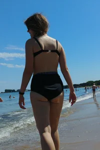 2 sexy friends in bikinis walking on the beach
