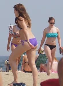 Cute girls in light blue and purple bikinis on the beach
