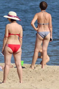 Couple of hot babes hanging out at the beach in bikinis