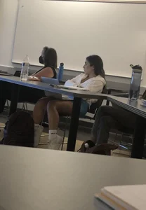 Candid student girl in shorts with hot legs sitting in auditorium creepshot