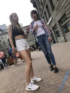 Hot Candid Girl in a Top, Shorts and Sneakers Skinny Legs Closeup Creepshots Gallery on the City Street