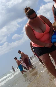 Thick lady on the beach with huge tits