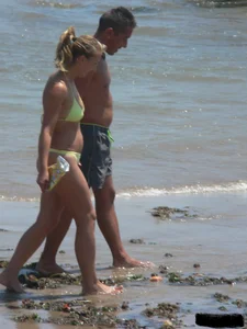 Sexy blonde on the beach in a yellow thong bikini