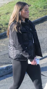 Pouting brunette teen in black leggings