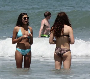 Brunette and redhead on the beach in bikinis looking sexy