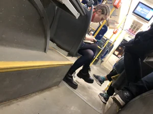 Cute candid teen wearing black pantyhose and boots sitting with crossed legs in a public bus creepshot