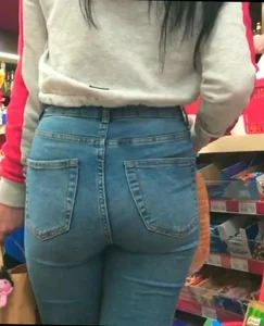 Skinny brunette with a nice booty in line in tight jeans
