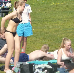 Teen taking off her dress in the park