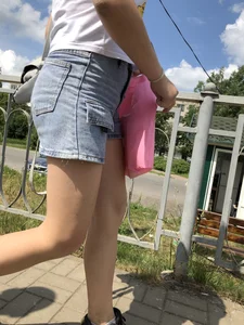 Cute Girl in Denim Shorts Walking Down a Railway Station Gallery