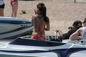 Brunette on a boat in red thong bikini with a tight little ass