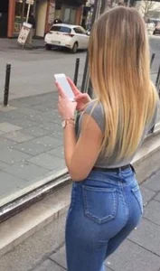 A few girls with tight asses in jeans waiting for